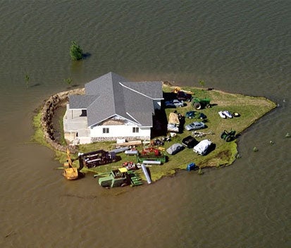 Arial view of house surrounded by flood water