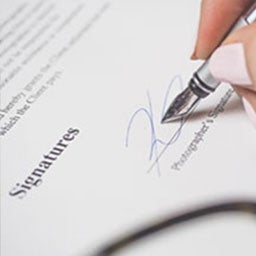 Image of person signing a form