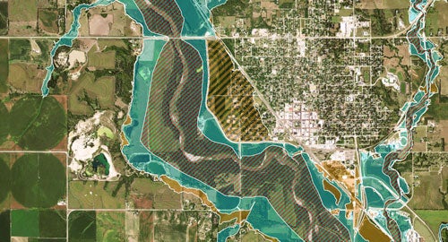 arial view of land with a blue area with stripes marked over the top