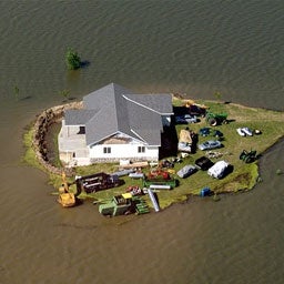 Arial view of house surrounded by flood water